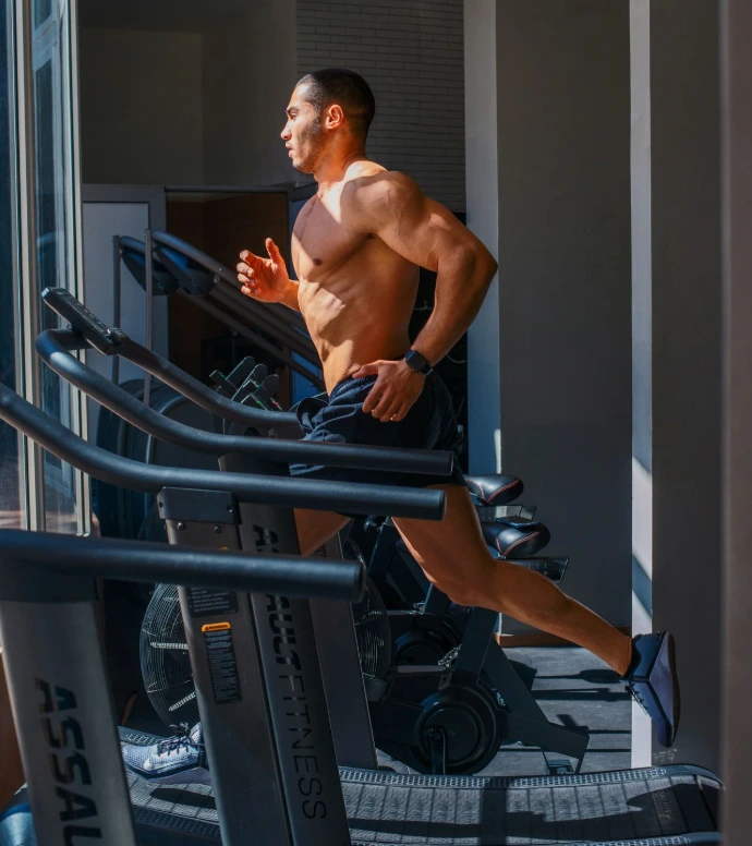 a man running on a treadmill in a gym